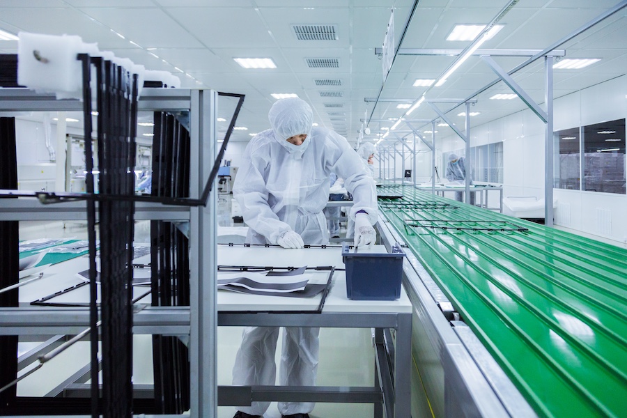 factory-workers-white-lab-suits-face-masks-producing-tv-sets-green-assembly-line-with-some-modern-equipment
